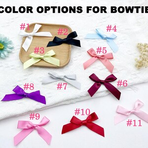 May include: An assortment of eleven satin bowties in various colors, including white, black, light blue, pink, purple, and red. The text "COLOR OPTIONS FOR BOWTIE" is at the top. Each bow is labeled with a number from 1 to 11.