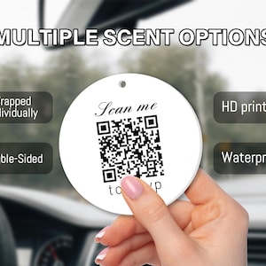 May include: A round white car air freshener featuring a black QR code with the text Scan me and to yp. The design includes labels for Multiple Scent Options, Wrapped Individually, HD printing, Double-Sided, and Waterproof features.