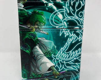May include: A green and white deck box featuring a character from the anime One Piece. The character is holding a sword and is surrounded by a green dragon design.