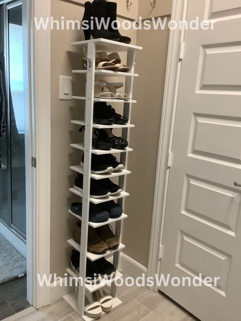 May include: White shoe rack with 10 shelves, holding a variety of shoes, including boots, sandals, sneakers, and dress shoes. The rack is labeled "Whims Woods Wonder".