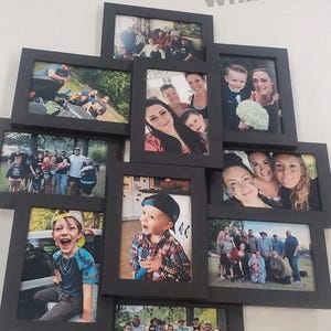 May include: A collage of black picture frames with various family photos. The frames are arranged in a geometric pattern on a white wall. The photos show a variety of people, including children, adults, and families.