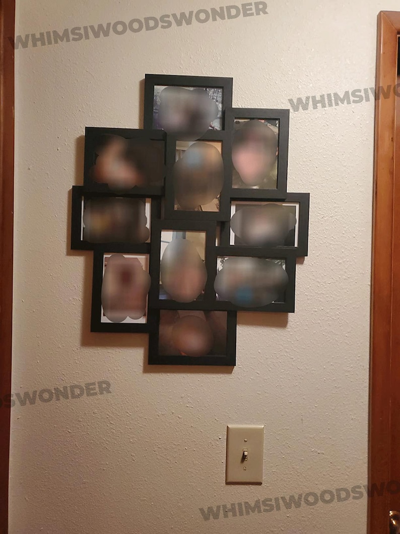 May include: A black picture frame collage with 10 individual frames, each containing a blurred image of a person. The frames are arranged in a heart shape on a white wall.