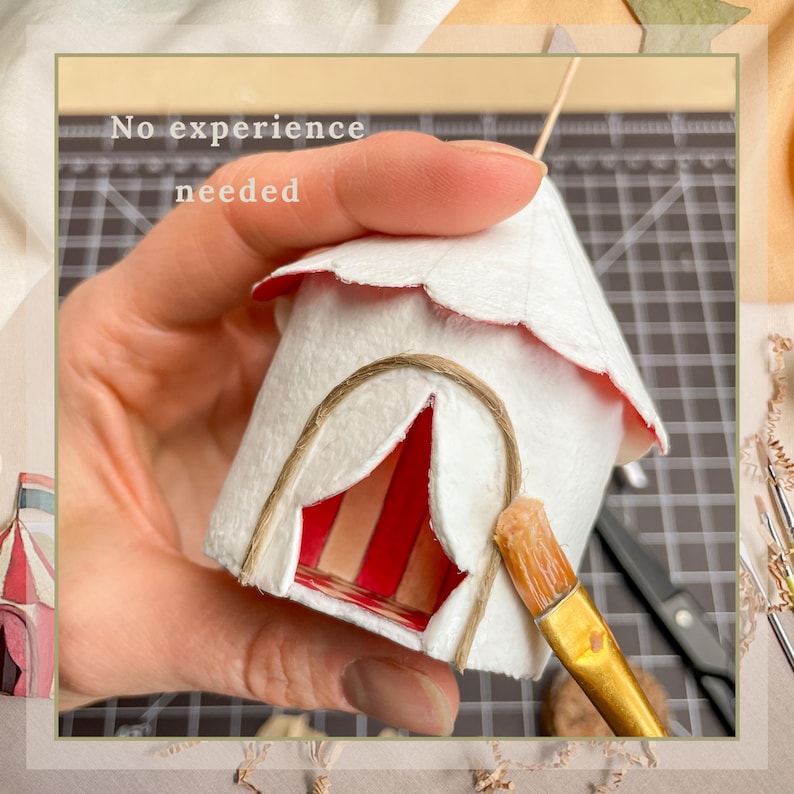 May include: A miniature white circus tent with a red and white striped entrance. The tent has a scalloped roof with red trim and is decorated with twine. The text "No experience needed" is visible.