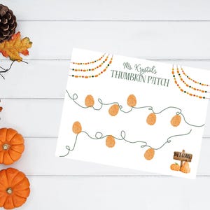 May include: A white paper with the text "Ms. Krystal's THUMBKIN PATCH" and pumpkin-shaped thumbprints. The design includes string lights with orange and green beads, and a small sign that says "WELCOME" with pumpkins. The image has a fall theme.
