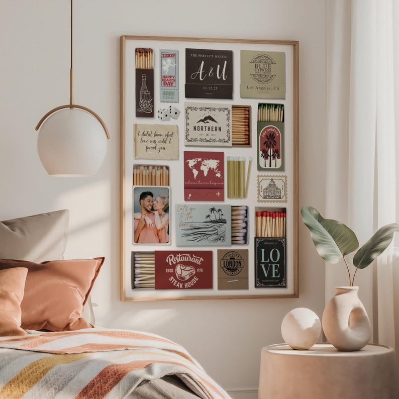 May include: A framed collection of matchboxes and small framed photos. The matchboxes feature various designs, including text that reads "A&U", "NORTHERN", "Restaurant Steak House", and "LO VE". The frame is mounted on a white wall.