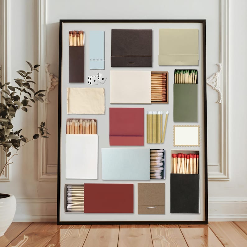 May include: A framed collection of various matchboxes in a grid arrangement. The matchboxes are in a variety of colors, including brown, beige, red, and green. Some boxes are open, revealing the matches inside. Two dice are also included.