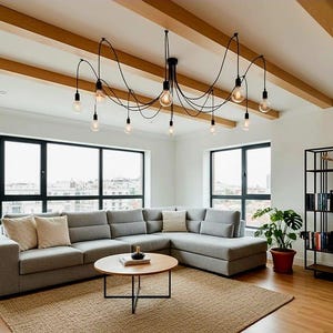 May include: A modern living room with a gray sectional sofa, a round wooden coffee table, and a jute rug. A black, spider-like chandelier with Edison bulbs hangs from the ceiling. Large windows offer a view of the city.