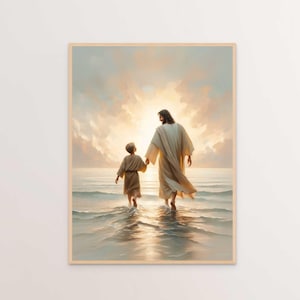 May include: A framed print depicts a serene scene of two figures walking in shallow water towards a bright, sunlit horizon. One figure, in a long white robe, holds the hand of a smaller figure in a similar garment. The artwork is rendered in soft, warm tones.