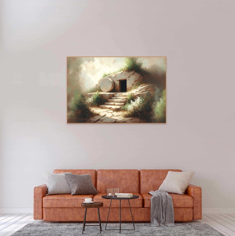 May include: A painting depicting a stone tomb with a large, round stone rolled away, revealing an open doorway. The tomb is situated on a hillside with green foliage and a path leading up to it. The scene is bathed in soft, warm light, suggesting a sense of hope and new beginnings.