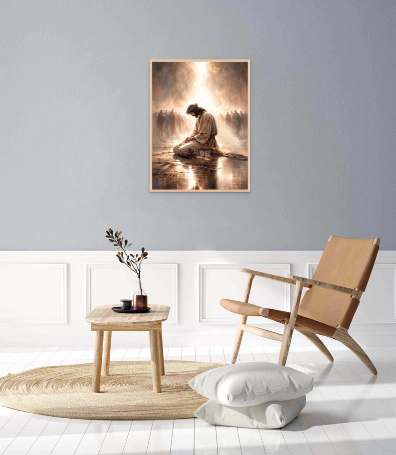 May include: A framed print depicts a figure kneeling in prayer, bathed in light. The artwork features a warm color palette with a soft, ethereal glow. The image is set against a backdrop of a crowd, with a reflective surface below the figure.