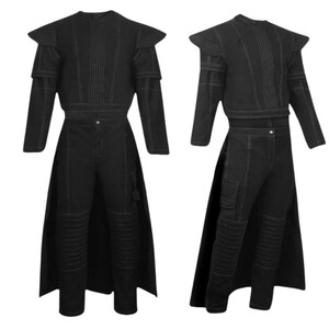 May include: A black two-piece outfit consisting of a long-sleeved top with structured shoulder pads and vertical stitching, paired with matching trousers featuring ribbed knee panels, a side pocket, and an attached long back panel or cape.