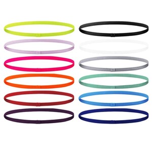 May include: A selection of thin, elastic headbands in a range of colours, such as neon green, pink, orange, and blue. These headbands are designed for sports and are displayed against a white backdrop.