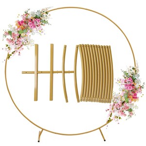 May include: A gold metal wedding arch with a circular design. The arch is partially assembled, with several pieces laid out. Floral arrangements with pink, white, and yellow flowers adorn the arch. The arch is designed to be a decorative backdrop for weddings and events.