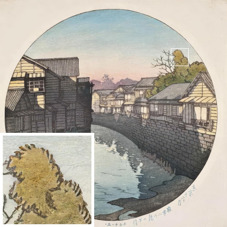 May include: A Japanese woodblock print depicting a canal scene with traditional houses lining the banks. The print is in shades of blue, gray, and brown, with a hint of pink in the sky. The text at the bottom reads "江戸の橋 二番橋".