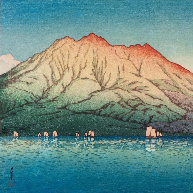 May include: A woodblock print depicting a mountain range with a red-orange peak, reflected in a still blue lake. Several small boats are visible in the water.