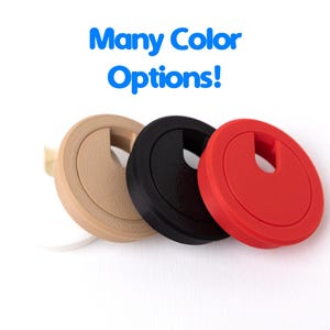 May include: Three desk grommets in beige, black, and red, each with a slot for cable management. The text "Many Color Options!" is displayed in blue above the grommets. These are designed to organize and conceal cables.