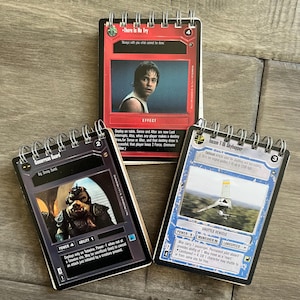 May include: Three Star Wars trading cards featuring a Gamorrean Guard, a character from the movie, a red card with the text "There is No Try" and a blue card with the text "Incom T-16 Skyhopper".