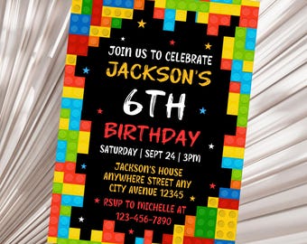 May include: A black and white birthday invitation with a colorful Lego border. The invitation says "Join us to celebrate Jackson's 6th Birthday" with the date and time of the party. The invitation also includes the address and RSVP information.