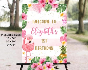May include: Pink flamingo welcome sign with tropical leaves and flowers. The sign says "Welcome to Elizabeth's 1st Birthday".