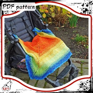 May include: A rainbow colored crochet baby blanket draped over a stroller. The blanket has a lacy pattern and is made with a gradient yarn.