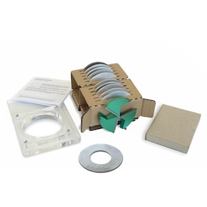 May include: An assortment of educational materials, including a clear acrylic frame, a cardboard holder with several silver discs, a small cardboard box, and a metal disc with braille text. A green, three-part shape is also included.