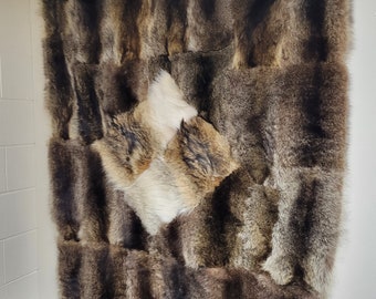 Raccoon and coyote fur throw blanket