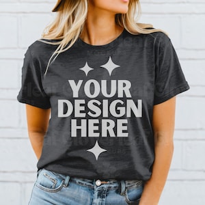 May include: A dark gray t-shirt with the text "YOUR DESIGN HERE" in white. The shirt has a distressed look and is being worn by a person.