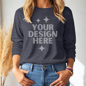 May include: A navy blue long-sleeved shirt with the text "YOUR DESIGN HERE" printed on the front. The shirt is made of a soft, comfortable material and has a relaxed fit.