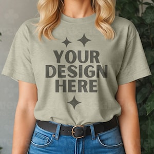 May include: A light green t-shirt with a simple design featuring the text "YOUR DESIGN HERE" and four small diamond shapes.