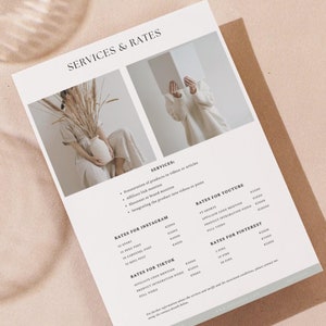 May include: A white sheet of paper with the text "SERVICES & RATES" at the top. The paper lists different services and rates for Instagram, TikTok, and Pinterest.
