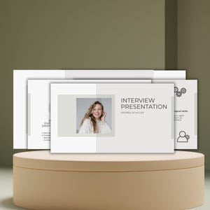 May include: A presentation titled "Interview Presentation" with a photo of a woman, displayed on a beige circular platform. The presentation has a light grey and white colour scheme. The background is a muted green.