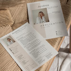 May include: Two resume templates with the name "Andrea Schiller" and the title "Deployment Manager" are displayed on a woven chair. One resume is open, showing work experience and skills. The other is a cover letter with the word "Application" and a photo of a woman.