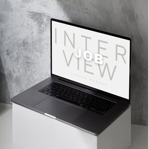 May include: A laptop computer with a white screen displaying the text "INTERVIEW JOB VIEW" and the name "SANDRA WAGNER".