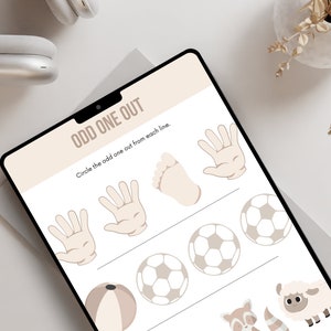 May include: A printable worksheet with the words "Odd One Out" and instructions to circle the odd one out from each line. The worksheet features three rows of images, including a hand, a foot, a football, a beach ball, a sheep, and a raccoon.