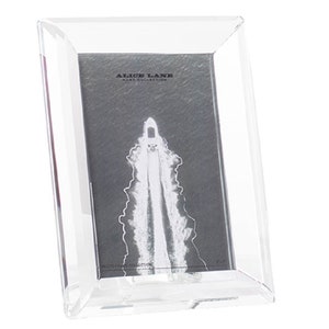 May include: A clear acrylic picture frame with a beveled edge. The frame is empty and ready to hold a photo. The frame is made by Alice Lane.