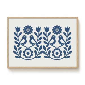 May include: A framed print with a blue and white folk art design featuring stylized birds, flowers, and leaves.