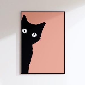May include: A framed art print with a minimalist design of a black cat peeking from the left. The cat's silhouette is black with white eyes, set against a peach background. The frame is black, creating a striking contrast.