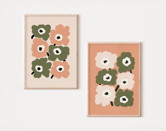 Può includere: Due stampe artistiche floreali incorniciate. Una stampa presenta fiori color pesca e verde oliva su sfondo beige chiaro. L'altra stampa ha fiori bianchi e verde oliva su sfondo pesca. Entrambe le stampe hanno uno stile minimalista.