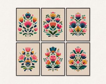Può includere: Sei stampe artistiche incorniciate con disegni floreali. Ogni stampa presenta una disposizione simmetrica di fiori rosa, blu, gialli e verdi su sfondo crema. Le cornici sono nere, creando un set coordinato.
