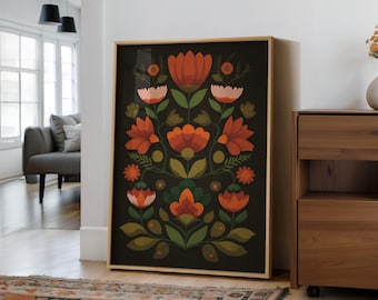 May include: A framed floral art print featuring a symmetrical design of stylized flowers in shades of orange, peach, and green against a dark background. The artwork is displayed in a room with natural light and wooden furniture.