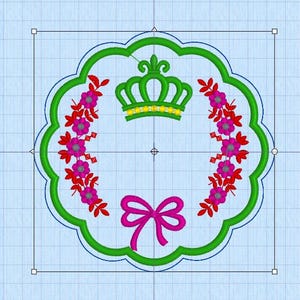 May include: An embroidered design featuring a green crown, pink flowers, red leaves, and a pink bow. The design is framed by a green scalloped border. The background is a light blue grid.