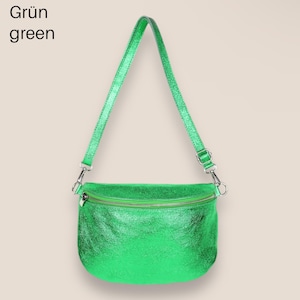 May include: A bright green metallic crossbody bag with a zipper closure. The bag has a long adjustable strap.