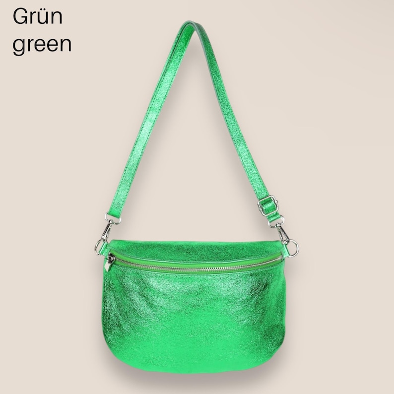 May include: A bright green metallic crossbody bag with a zipper closure. The bag has a long adjustable strap.