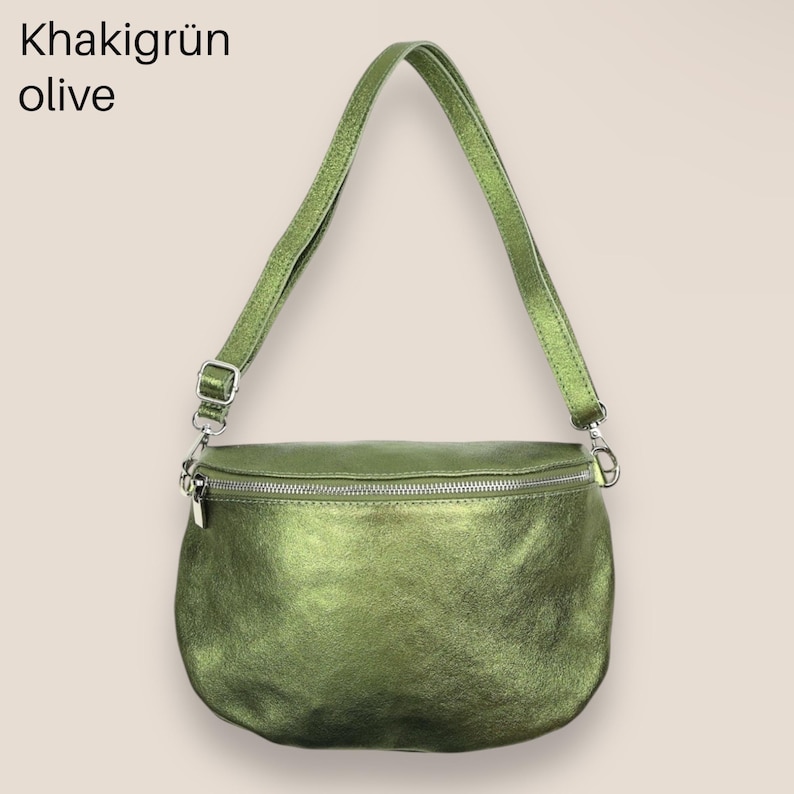 May include: A green leather fanny pack with a silver zipper and adjustable strap. Khaki gr&uuml;n olive.