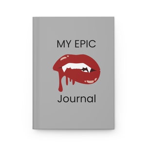 May include: Gray journal cover with the text "MY EPIC JOURNAL" in black. A red, dripping vampire mouth with fangs is in the center of the cover.