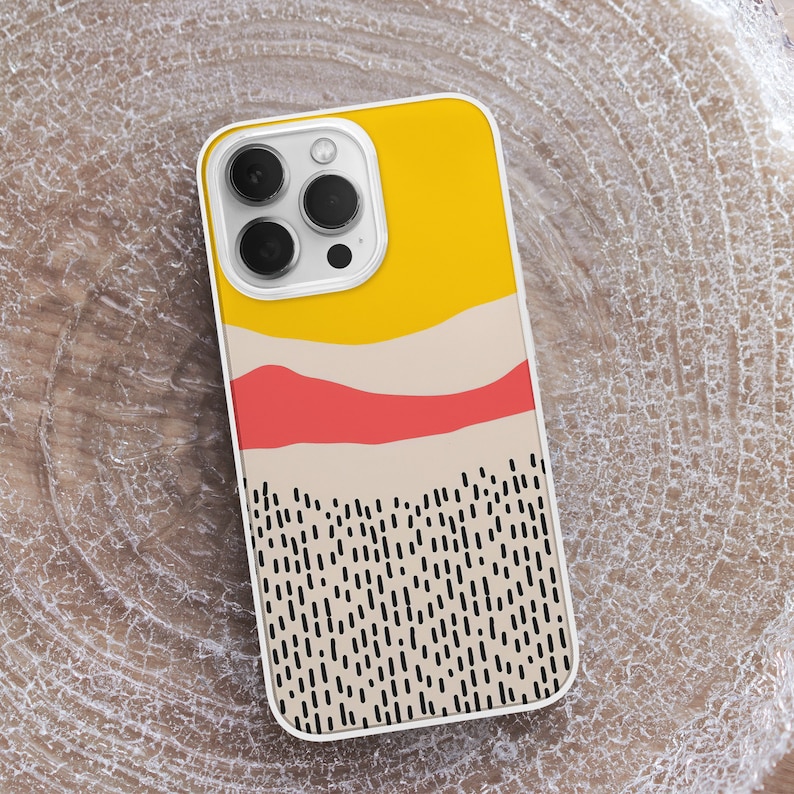 May include: A white phone case with a yellow, red, and beige abstract design. The design features a wavy line and a pattern of black dashes.