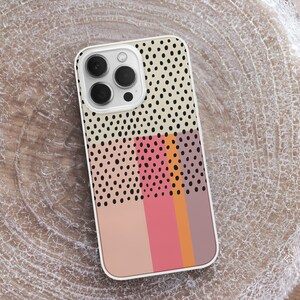 May include: A white phone case with a geometric pattern of black dots and stripes in pink, orange, and brown.