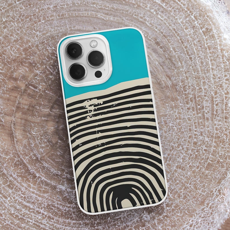 May include: White phone case with a blue and black abstract design. The design features a series of concentric circles with a black and white striped pattern.