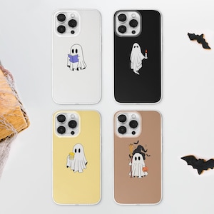 May include: Four different iPhone cases with a Halloween theme. Each case features a white ghost with different accessories. The first case has a ghost reading a book, the second has a ghost holding a candle, the third has a ghost holding a beer, and the fourth has a ghost wearing a witch's hat and holding a pumpkin.