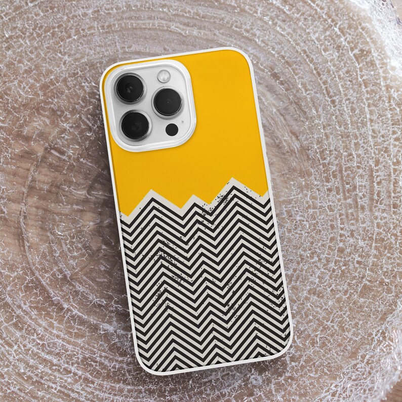 May include: A yellow and black phone case with a geometric chevron pattern. The case has a cutout for the camera lens.